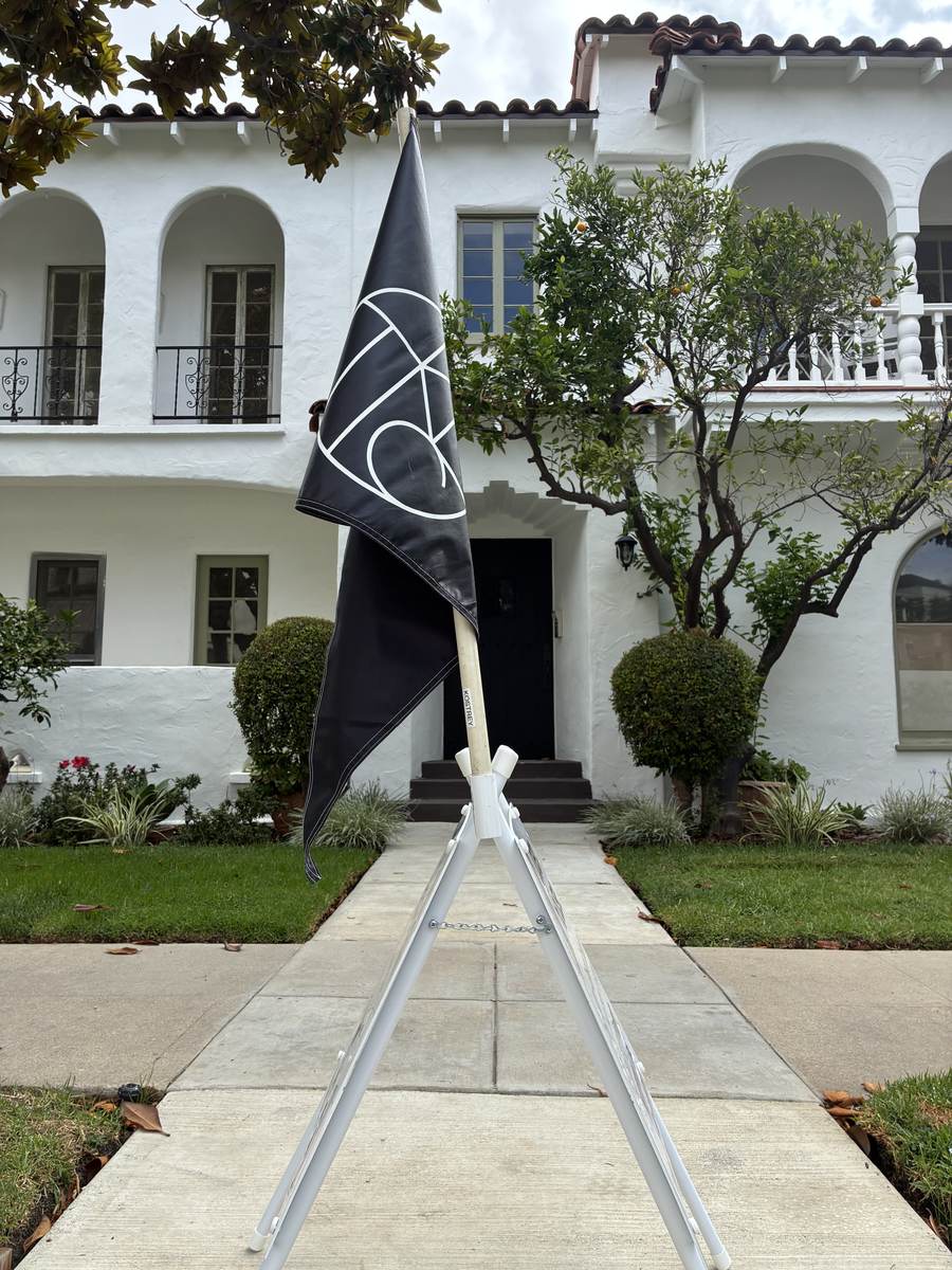 LA Sign Delivery directional flag placed at a Spanish revival home